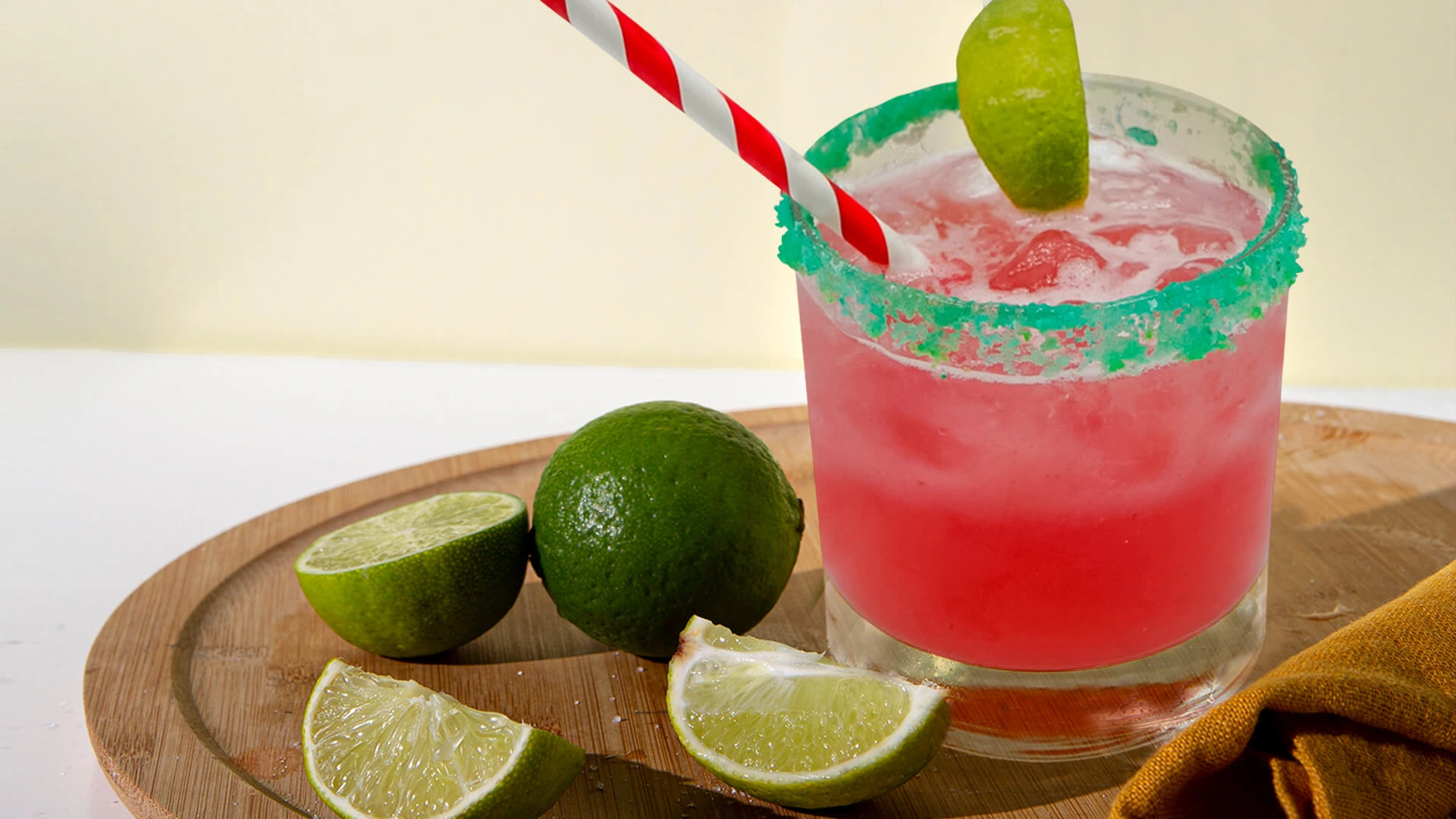 Pink cocktail with lemon and straw on white background